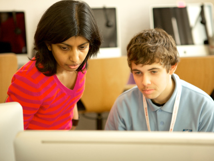 CLC Tutor assisting a pupil at a computer